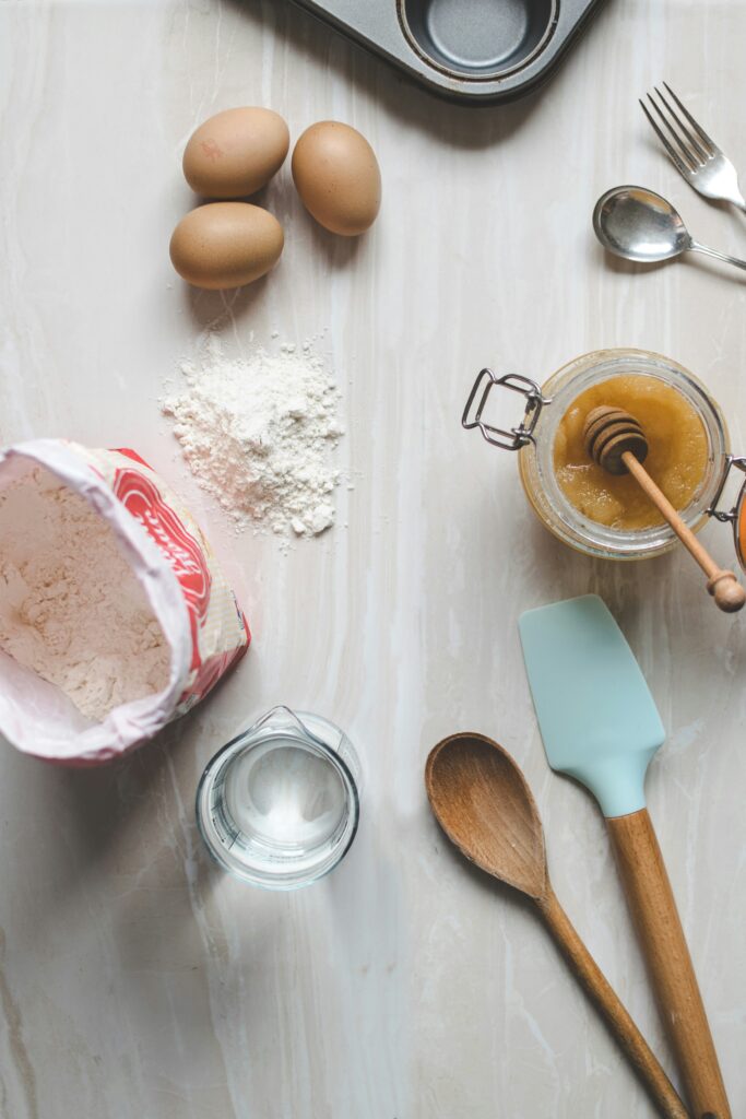 Flat lay of baking ingredients and utensils on a table